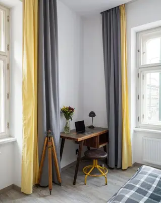 a desk in front of a window with curtains at Urban Wave Apartment in Prague