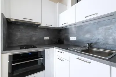 a kitchen with white cabinets and a sink at 12 min Centrum, 200Mb WIFI, Onsite Supermarket in Prague