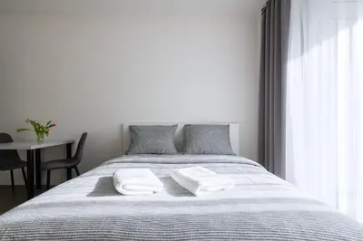 a bedroom with a bed with two towels on it at 12 min Centrum, 200Mb WIFI, Onsite Supermarket in Prague