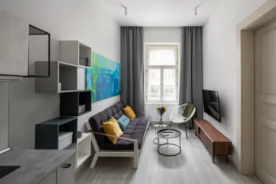 a living room with a couch and a tv at Ocean Breeze Apartment in Prague
