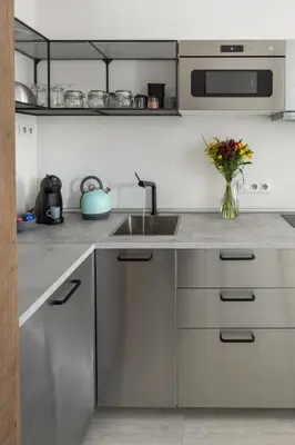 a kitchen with a sink and a vase of flowers at Ocean Breeze Apartment in Prague
