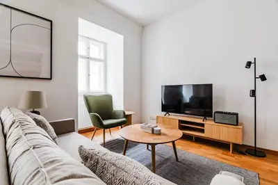 a living room with a couch and a tv at Blueground Prague 1 furnished Old town square PRG-43 in Prague