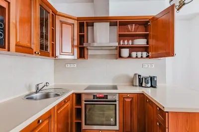 a kitchen with wooden cabinets and a sink at Blueground Prague 1 furnished Old town square PRG-43 in Prague