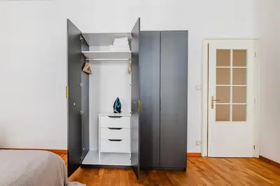 a bedroom with a bed and a white cabinet at Blueground Prague 1 furnished Old town square PRG-43 in Prague