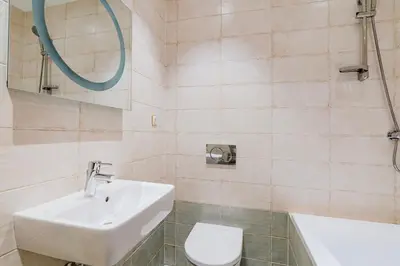 a bathroom with a sink and a toilet and a tub at Blueground Prague 1 furnished Old town square PRG-43 in Prague