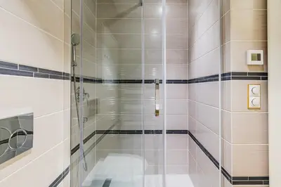 a shower with a glass door in a bathroom at Blueground Prague 1 furnished Old town square PRG-43 in Prague