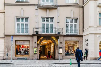 a man walking in front of a store at Blueground Prague 1 furnished Old town square PRG-43 in Prague