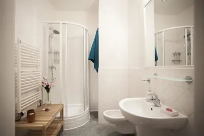 a bathroom with a sink and a shower and a toilet at Charles Bridge Apartment in Prague
