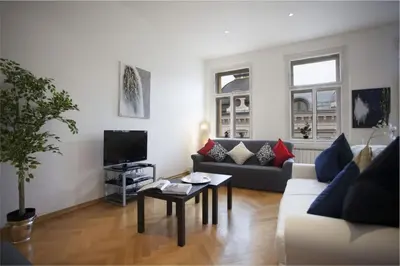 a living room with a couch and a table at Charles Bridge Apartment in Prague