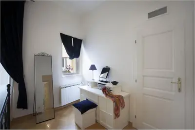 a white room with a mirror and a white door at Charles Bridge Apartment in Prague