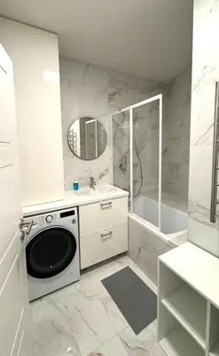 a white bathroom with a washing machine and a sink at Short Way Apartments in Prague