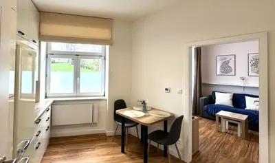 a small room with a table and a bed at Short Way Apartments in Prague