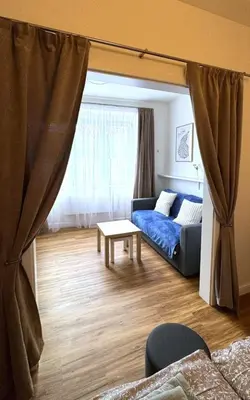 a living room with a couch and a table at Short Way Apartments in Prague