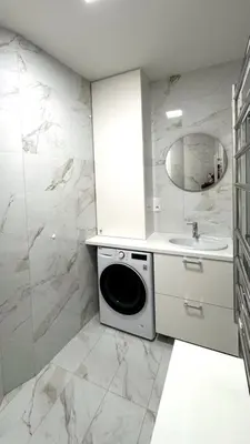 a white bathroom with a sink and a washing machine at Short Way Apartments in Prague