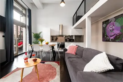 a living room with a couch and a table at Modern loft-apartments in Prague in Prague