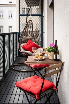 a table on a balcony with a glass of wine at Modern loft-apartments in Prague in Prague