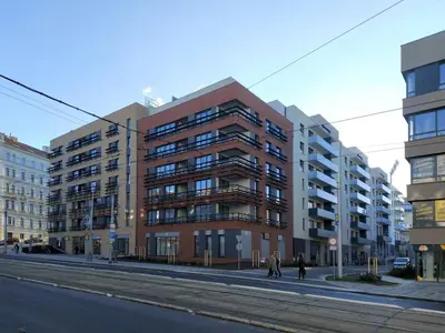 a building on a street with people walking in front of it at Viktoria Suite N3 with Garage & Balcony in Prague