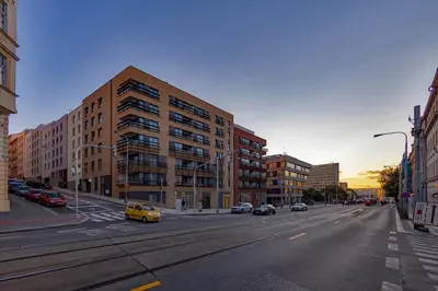 an empty street in a city with buildings and cars at Viktoria Suite N3 with Garage & Balcony in Prague