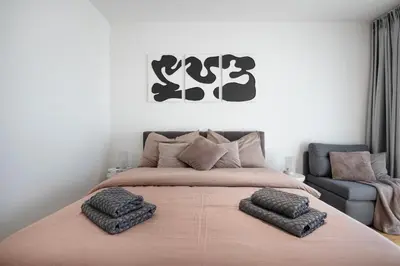 a bedroom with a large bed with two pillows on it at Viktoria Suite N3 with Garage & Balcony in Prague