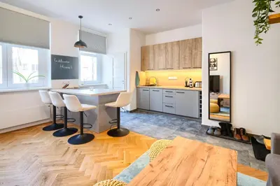 a kitchen with a table and chairs in a room at Apartmán Flora in Prague