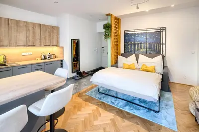 a bedroom with a bed and a table and chairs at Apartmán Flora in Prague