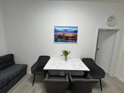 a living room with a table and a couch at Modern, comfortable apartments near the metro in Prague