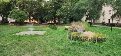 a park with a fountain and flowers in the grass at Modern, comfortable apartments near the metro in Prague