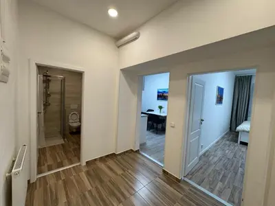 a hallway with a door leading to a room with a table at Modern, comfortable apartments near the metro in Prague
