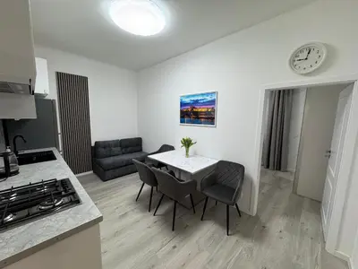 a kitchen and living room with a table and chairs at Modern, comfortable apartments near the metro in Prague