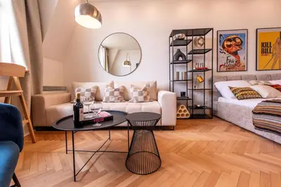 a living room with a couch and a table at Sunny & Quiet studio in peaceful hood,metro access in Prague