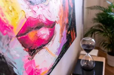 a painting and a glass of wine on a table at Sunny & Quiet studio in peaceful hood,metro access in Prague
