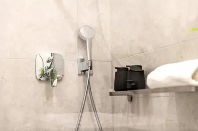 a shower in a bathroom with a shower head at Sunny & Quiet studio in peaceful hood,metro access in Prague