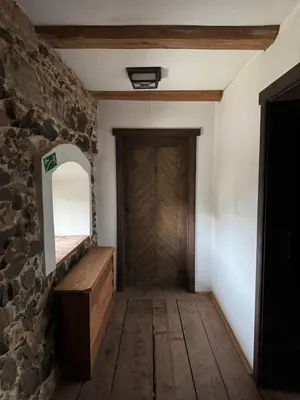 a hallway with a wooden floor and a wooden door at Ekologická farma Skřivaň in Skřivaň