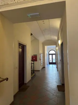 an empty hallway in a building with a ceiling at Tyrsova Apartment City Centre in Prague