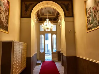 a hallway with a chandelier and a red carpet at Apartment with a terrace and AC in the city center in Prague