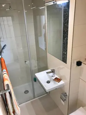 a bathroom with a sink and a shower at Apartment with a terrace and AC in the city center in Prague
