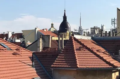 a view of roofs of a city with buildings at Apartment with a terrace and AC in the city center in Prague