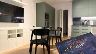 a book sitting on a chair in a kitchen at NEW STYLISH APARTMENT Varta Alpha 2025 & Parking in Prague