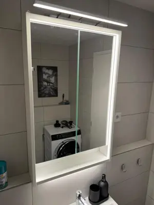 a mirror over a sink in a bathroom with a stove at NEW STYLISH APARTMENT Varta Alpha 2025 & Parking in Prague