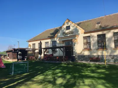 a large white house with a yard with a playground at U dobroty in Nový Dŭm