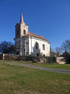 an old church with a clock tower on a field at U dobroty in Nový Dŭm