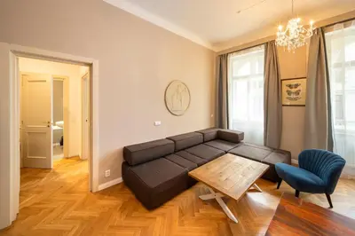 a living room with a black couch and a table at 1 Bed Flat - Sleeps 5 - Parking - Wifi in Prague