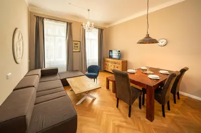 a living room with a couch and a table with chairs at 1 Bed Flat - Sleeps 5 - Parking - Wifi in Prague