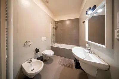 a white bathroom with a sink and a toilet at 1 Bed Flat - Sleeps 5 - Parking - Wifi in Prague
