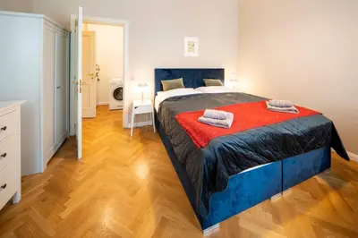 a bedroom with a large bed with a red blanket at 1 Bed Flat - Sleeps 5 - Parking - Wifi in Prague