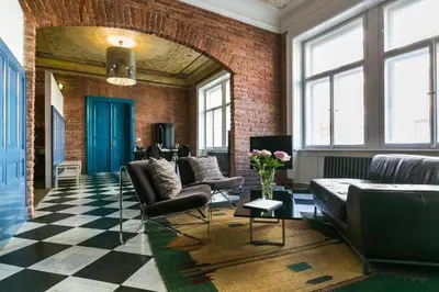 a living room with leather furniture and a brick wall at 2 Bed Flat - Sleeps 3 - Wifi in Prague