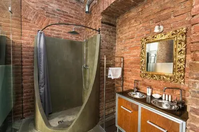 a brick bathroom with a shower and a sink at 2 Bed Flat - Sleeps 3 - Wifi in Prague