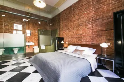 a bedroom with a large bed and a brick wall at 2 Bed Flat - Sleeps 3 - Wifi in Prague