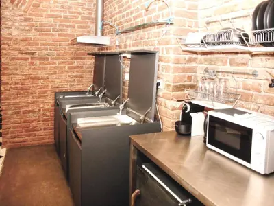 a kitchen with sinks and a brick wall at 2 Bed Flat - Sleeps 3 - Wifi in Prague