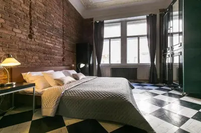 a bedroom with a bed and a brick wall at 2 Bed Flat - Sleeps 3 - Wifi in Prague